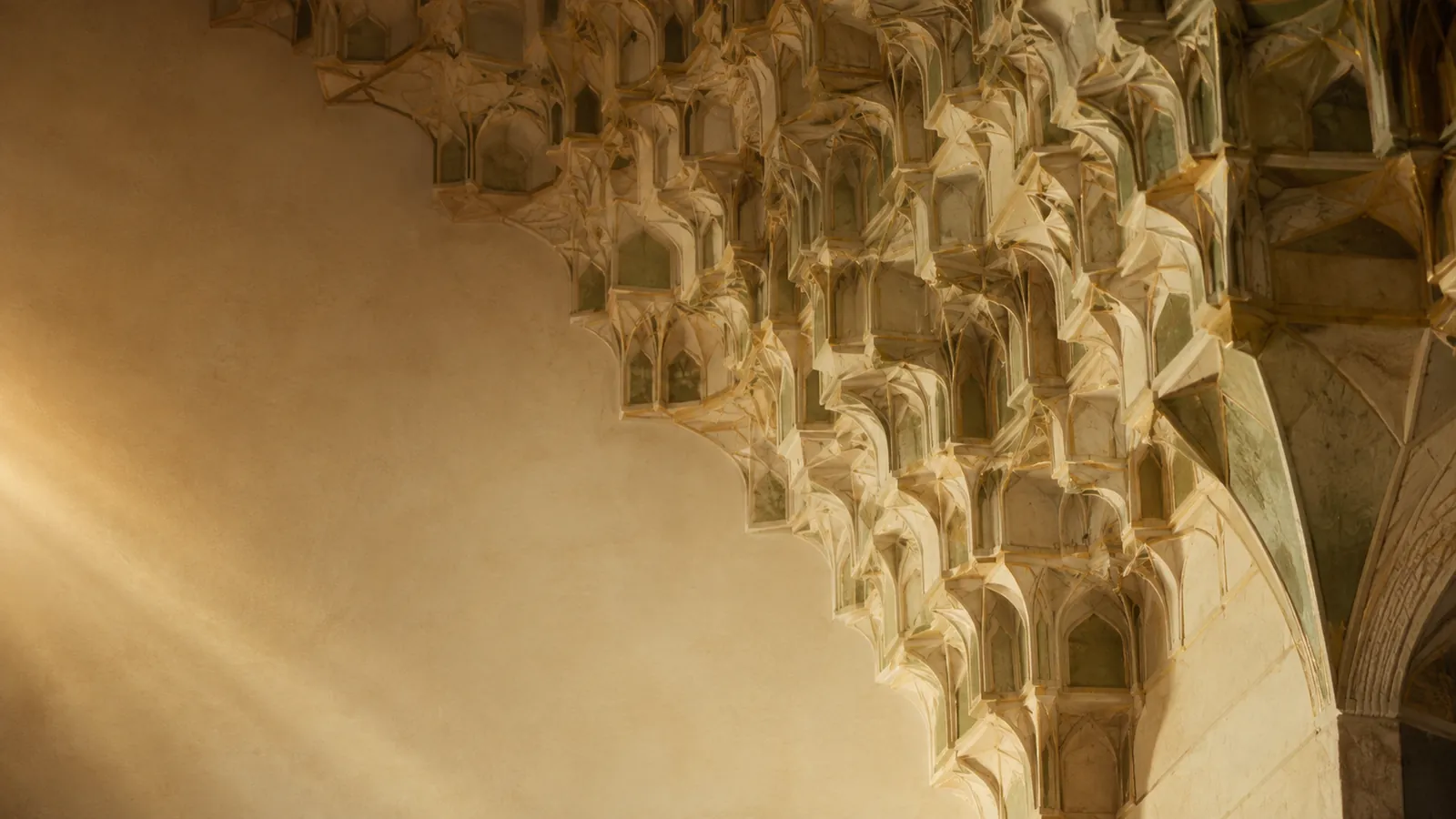 Geometric vaulting of a mosque ceiling in warm light